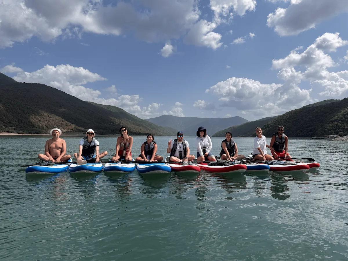 SUP paddleboarding on Zhinvali Reservoir turquoise water near Tbilisi